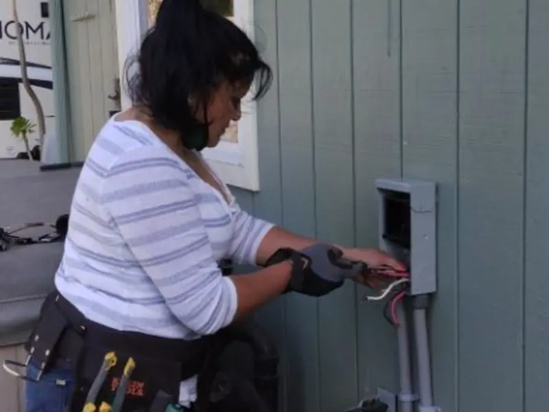 Licensed electrician wiring an exterior subpanel in Sausalito